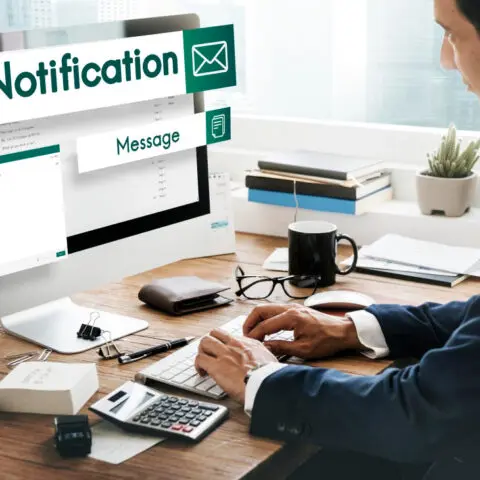 Person managing multiple email follow-ups on a computer screen.