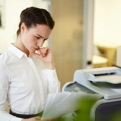 Office printer on a desk consuming resources