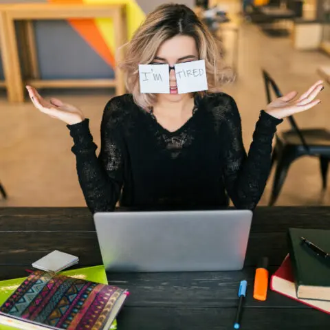 Office worker taking a break with a coffee in a quiet space.
