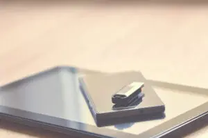 USB stick and paper with text overlay exploring photocopy definition for digital and physical documents. Short, descriptive.