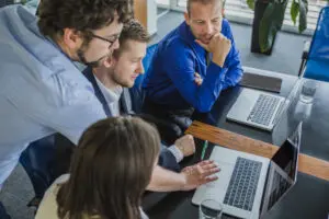 Team members successfully complete a new tech training exercise in an office setting.