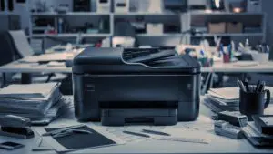 A modern office setting showing an old metal filing cabinet being phased out in favour of a sleek digital workstation where an AI-powered interface manages data, highlighting the digital document management benefits for SMEs in 2026.