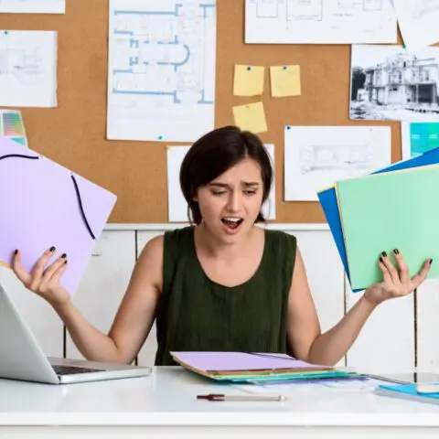 A focused employee working at a clean, modern desk to illustrate managed print services employee productivity.