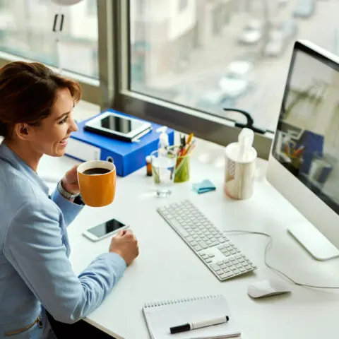 A focused employee working at a modern, organized desk, illustrating managed print services employee productivity.