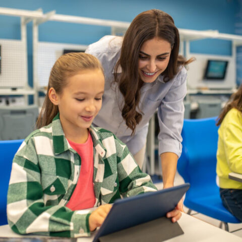 A classroom with digital tablets replacing paper, symbolising a shift to eco-friendly practices.