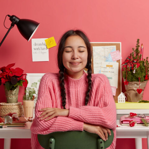 Productivity Habits and Rituals: Calm person at organised desk with free time, showing control and accomplishment.