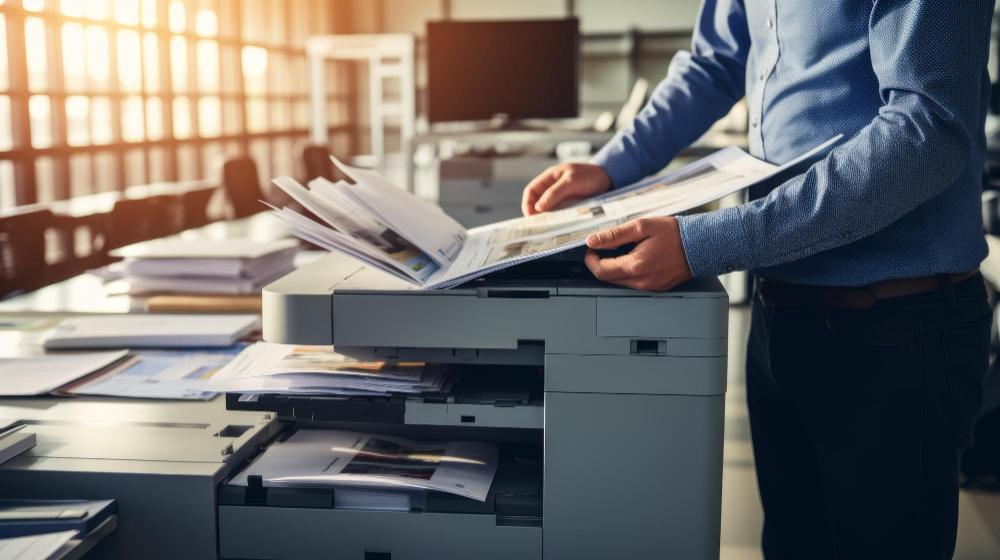 Printed emails overflowing a tray, illustrating Email Printing Anxiety. A hand hovers over the print button, showing inefficiency and waste.