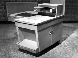 Close-up of a damaged vintage Xerox 914 copier showing smoke and the Xerox 914 Scorch Eliminator label plaque.