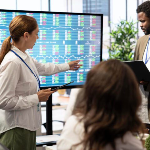 Digital Office Strategy shown by modern office with digital screens displaying growth metrics to maximise efficiency