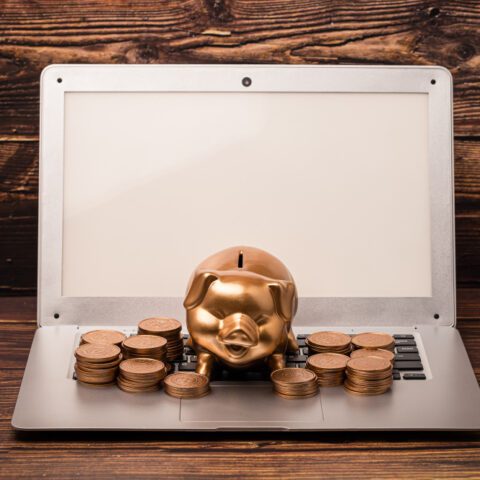 Dusty scanner buried in pound coins shows high Outdated Scanning Software Cost and lost revenue.