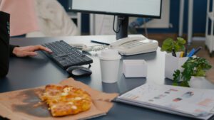 Outdated office equipment cost: Paper-jammed printer and laptop graph show inefficiency. Maximise savings.