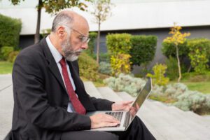 Business owner reviews automated records on a laptop to plan a tax year wealth strategy and maximise growth.