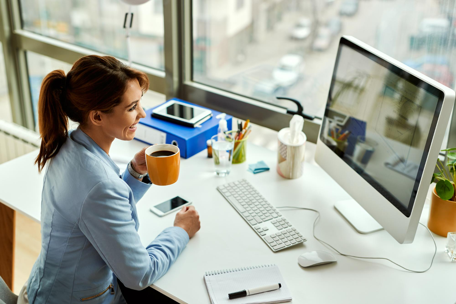 A focused employee working at a modern, organized desk, illustrating managed print services employee productivity.