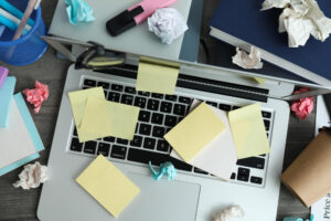A frustrated office worker searches through disorganized digital files on a computer screen.