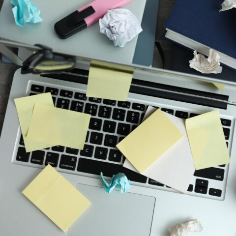 A frustrated office worker searches through disorganized digital files on a computer screen.